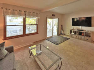 The master living room. Has large flat screen tv and sliding patio doors to deck