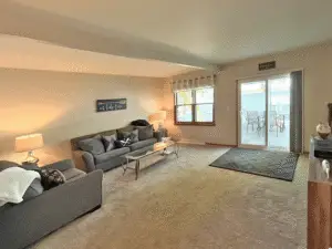 The master living room. Has large flat screen TV and sliding patio doors to deck
